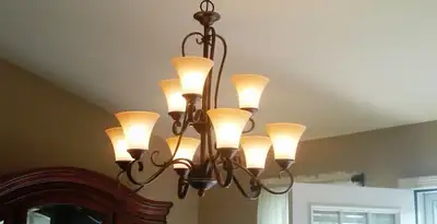 Classic ceiling chandelier installation with warm lighting in Richmond, VA