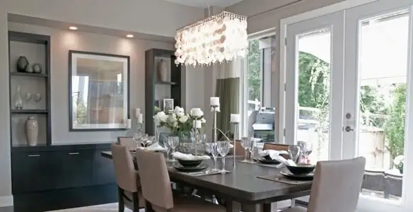 Elegant dining room chandelier installation above table in Richmond, VA
