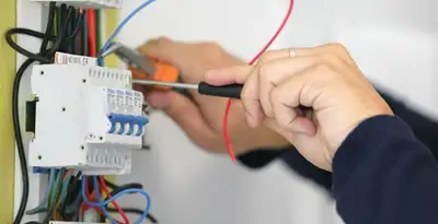 Electrician installing and adjusting circuit breakers in an electrical panel in Richmond, VA