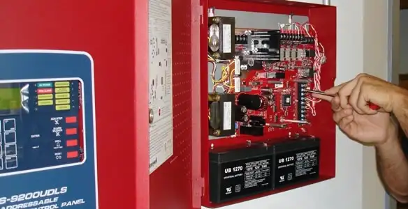 fire alarm installation service showing technician configuring fire alarm control panel in Richmond, VA