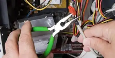 Licensed electrical contractor performing electrical repair with tools in Midlothian, VA