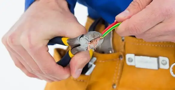 licensed electrician securing electrical wiring with professional tools during service work in Richmond, VA