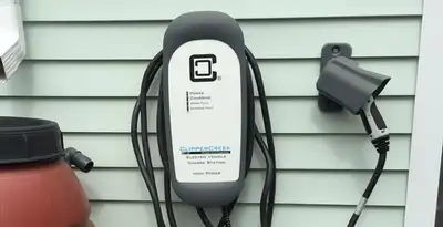 Outdoor electric vehicle charger installation on residential wall in Richmond, VA